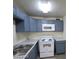 Cozy kitchen featuring blue cabinets, white appliances, and ample counter space at 304 Orland St # 39, Las Vegas, NV 89107