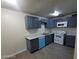 Updated kitchen featuring modern appliances, granite countertops and blue cabinets at 304 Orland St # 39, Las Vegas, NV 89107