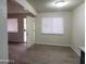 Inviting living room with large window, entry door, and wood-look flooring at 304 Orland St # 39, Las Vegas, NV 89107