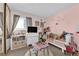 Cozy bedroom with pink walls and a large window at 4301 Fortune Ave, Las Vegas, NV 89107