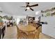 Bright dining area with wood table, ceiling fan and view of kitchen and living room at 4301 Fortune Ave, Las Vegas, NV 89107