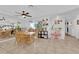 Bright dining area with wood table, ceiling fan, decor and access to other rooms at 4301 Fortune Ave, Las Vegas, NV 89107