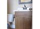 Bathroom featuring wood cabinetry, a white sink, toilet, and oil rubbed bronze fixtures at 4320 Tiger Rd, Pahrump, NV 89048