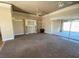 Spacious living room with neutral paint, carpet flooring, and sliding glass doors at 4320 Tiger Rd, Pahrump, NV 89048