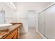 Bathroom with tiled floors, marble counter tops, and glass enclosed shower at 502 Edgefield Ridge Pl, Henderson, NV 89012