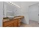 Bathroom with modern countertop, vessel sink, large mirror, and open doorway at 502 Edgefield Ridge Pl, Henderson, NV 89012