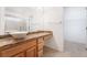 Well-lit bathroom features a vessel sink, decorative countertop, and shower with glass doors, leading to walk-in closet at 502 Edgefield Ridge Pl, Henderson, NV 89012