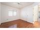 Cozy bedroom featuring hardwood floors, white ceiling fan and window at 502 Edgefield Ridge Pl, Henderson, NV 89012