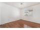 This bedroom boasts hardwood floors, a ceiling fan, and window at 502 Edgefield Ridge Pl, Henderson, NV 89012