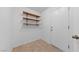 Clean hallway with tiled floor, shelves, and a door at 502 Edgefield Ridge Pl, Henderson, NV 89012