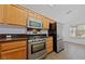 Well-equipped kitchen with stainless steel appliances and wood cabinetry at 502 Edgefield Ridge Pl, Henderson, NV 89012