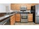 Well-lit kitchen features stainless steel appliances and wooden cabinetry at 502 Edgefield Ridge Pl, Henderson, NV 89012