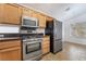 Cozy kitchen with stainless steel appliances and warm tile flooring at 502 Edgefield Ridge Pl, Henderson, NV 89012