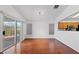 Open floor plan living room with hardwood floors and sliding glass doors at 502 Edgefield Ridge Pl, Henderson, NV 89012