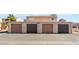 Exterior shot of garage featuring multiple brown doors and number 5166 at 5166 Gray Ln # M, Las Vegas, NV 89119