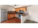 Well-lit kitchen featuring stainless steel appliances, wood cabinets, and tile backsplash at 5166 Gray Ln # M, Las Vegas, NV 89119