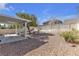 This is the backyard with a covered patio and desert landscaping at 5323 Farley Feather Ct, North Las Vegas, NV 89031