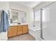 Bathroom boasts double sinks, wood cabinets, a bathtub, and a glass-enclosed shower at 5323 Farley Feather Ct, North Las Vegas, NV 89031