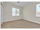 Bright bedroom featuring neutral carpeting, fresh paint, and double windows providing plenty of natural light at 5323 Farley Feather Ct, North Las Vegas, NV 89031