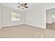 Bright bedroom with neutral carpet, ceiling fan, and a large window at 5323 Farley Feather Ct, North Las Vegas, NV 89031