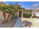 Home exterior featuring a tiled roof, small shrubs, and desert rock landscaping at 5323 Farley Feather Ct, North Las Vegas, NV 89031