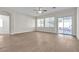 Bright living room with wood floors, ceiling fan, and sliding door access to the outdoor space at 5323 Farley Feather Ct, North Las Vegas, NV 89031