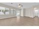 Light-filled living room boasts wood floors, neutral walls, large windows, and sliding door access to the backyard at 5323 Farley Feather Ct, North Las Vegas, NV 89031