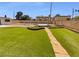 Backyard with artificial lawn, stone walking path, and backyard pergola at 5413 Avenida Caballo, Las Vegas, NV 89108