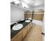 Bright bathroom featuring dual sinks, granite countertops, and a tiled shower-tub combination at 5413 Avenida Caballo, Las Vegas, NV 89108