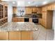 Well-lit kitchen with oak cabinets, granite countertops, stainless steel appliances, and tiled backsplash at 5413 Avenida Caballo, Las Vegas, NV 89108