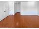 Living room with wood look floors and all-white walls and doors at 5413 Avenida Caballo, Las Vegas, NV 89108