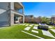 Modern backyard features a fire pit, stepping stones, and lush artificial turf at 59 Strada Loreto, Henderson, NV 89011