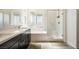 Elegant bathroom featuring double sinks, a soaking tub, and a glass-enclosed shower at 59 Strada Loreto, Henderson, NV 89011