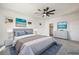 Nicely staged bedroom with a ceiling fan, carpet and large windows at 59 Strada Loreto, Henderson, NV 89011