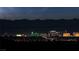 Night shot of the Las Vegas skyline at night with mountains in the background at 59 Strada Loreto, Henderson, NV 89011