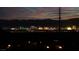 Night shot of the Las Vegas skyline with mountains in the background and power lines overhead at 59 Strada Loreto, Henderson, NV 89011