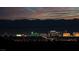 Night shot of the Las Vegas skyline with mountains in the background and a colorful sky at 59 Strada Loreto, Henderson, NV 89011