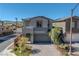 Charming two-story home with a well-manicured front yard, showcasing a modern design and convenient two-car garage at 59 Strada Loreto, Henderson, NV 89011