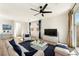 Bright living room with a fan, sofa, blue pillows, and sliding glass doors at 59 Strada Loreto, Henderson, NV 89011