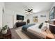 Bright main bedroom with a ceiling fan, TV, and view from the window at 59 Strada Loreto, Henderson, NV 89011