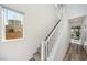 Bright staircase with carpeted steps and white railings leads to the upper level at 59 Strada Loreto, Henderson, NV 89011