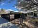 The front yard includes desert landscaping, a black fence and mature trees that provide natural shade at 617 S 9Th St, Las Vegas, NV 89101