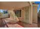 View of a covered outdoor back patio, a security screen door and adjacent window at 6190 Tillman Crest Ave, Las Vegas, NV 89139