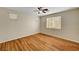 Clean bedroom featuring wood floors, a ceiling fan, and bright windows at 6190 Tillman Crest Ave, Las Vegas, NV 89139