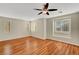 Spacious bedroom with ceiling fan, wood floors, and natural light from multiple windows at 6190 Tillman Crest Ave, Las Vegas, NV 89139