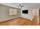 Serene bedroom with wood floors, ceiling fan, and a view of the en-suite bathroom at 6190 Tillman Crest Ave, Las Vegas, NV 89139