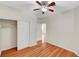 This bedroom features neutral walls, a ceiling fan, wood-look floors, and closet at 6190 Tillman Crest Ave, Las Vegas, NV 89139