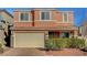 Two-story home with a neutral-toned exterior, a two-car garage, and manicured landscaping at 6190 Tillman Crest Ave, Las Vegas, NV 89139