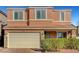 Two-story home with a neutral-toned exterior, a two-car garage, and manicured landscaping at 6190 Tillman Crest Ave, Las Vegas, NV 89139