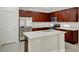 Modern kitchen with dark wood cabinets, white countertops, and stainless steel appliances at 6190 Tillman Crest Ave, Las Vegas, NV 89139